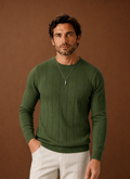 Front view of crew neck sweater in green on a neutral background