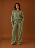 Front view of a women's two-piece sweatsuit set showing sweatshirt and matching pants on a mannequin