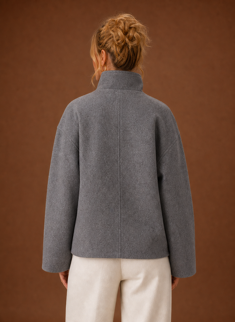 Back view of a women's funnel neck jacket in grey