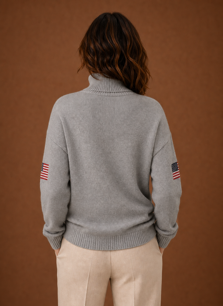 Back view of women's turtleneck sweater highlighting the turtleneck and shoulder seams