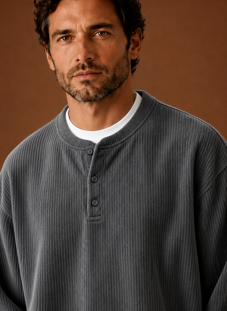 Close-up of ribbed texture and button placket on men's henley shirt