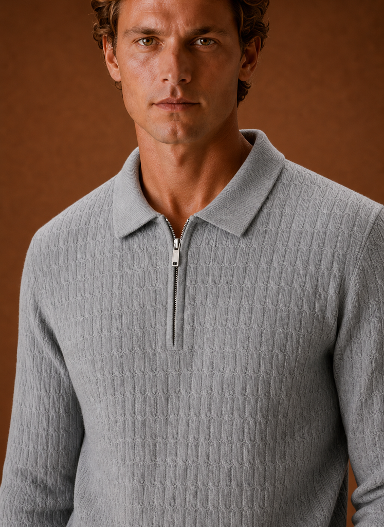 Close-up of chunky ribbed knit texture and half-zip hardware on the pullover