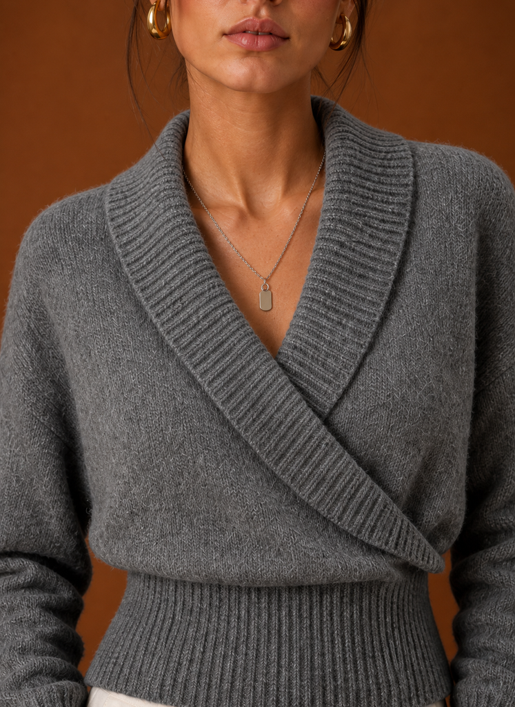 Close-up of ribbed knit texture and shawl collar V-neck detailing on the wrap sweater