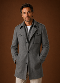 Front view of men's long coat showing single-breasted button front and tailored silhouette