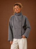 Front view of a women's funnel neck jacket in grey