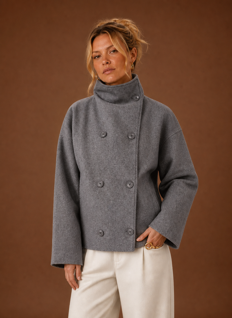 Front view of a women's funnel neck jacket in grey