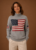 Front view of women's turtleneck sweater featuring an American flag motif