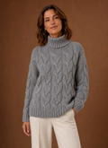 Front view of Areleon cable knit sweater showing full front cable pattern