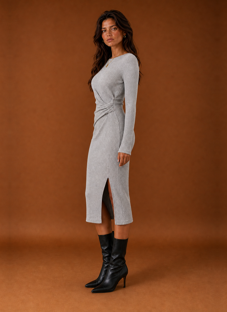 Side profile of women's sweater dress displaying drape and fit