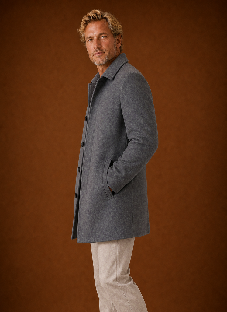 Side profile of a men's mid-length overcoat displaying the straight fall of the hem