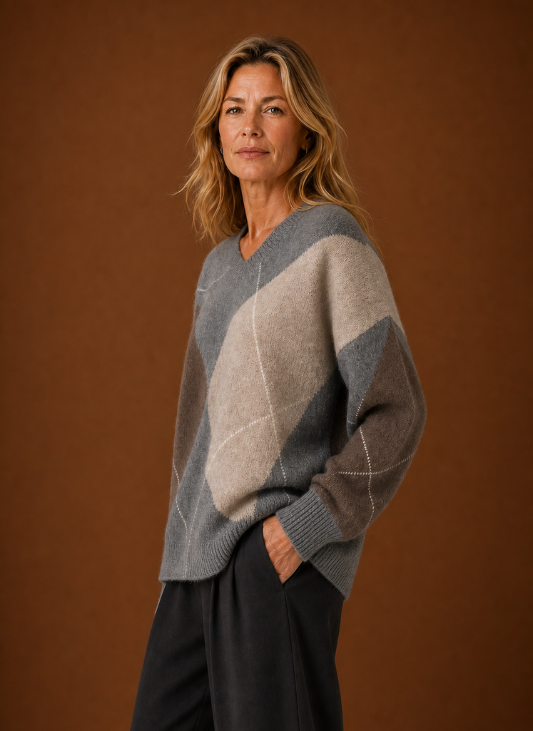 Side view of women's oversized argyle pullover highlighting relaxed fit and drape