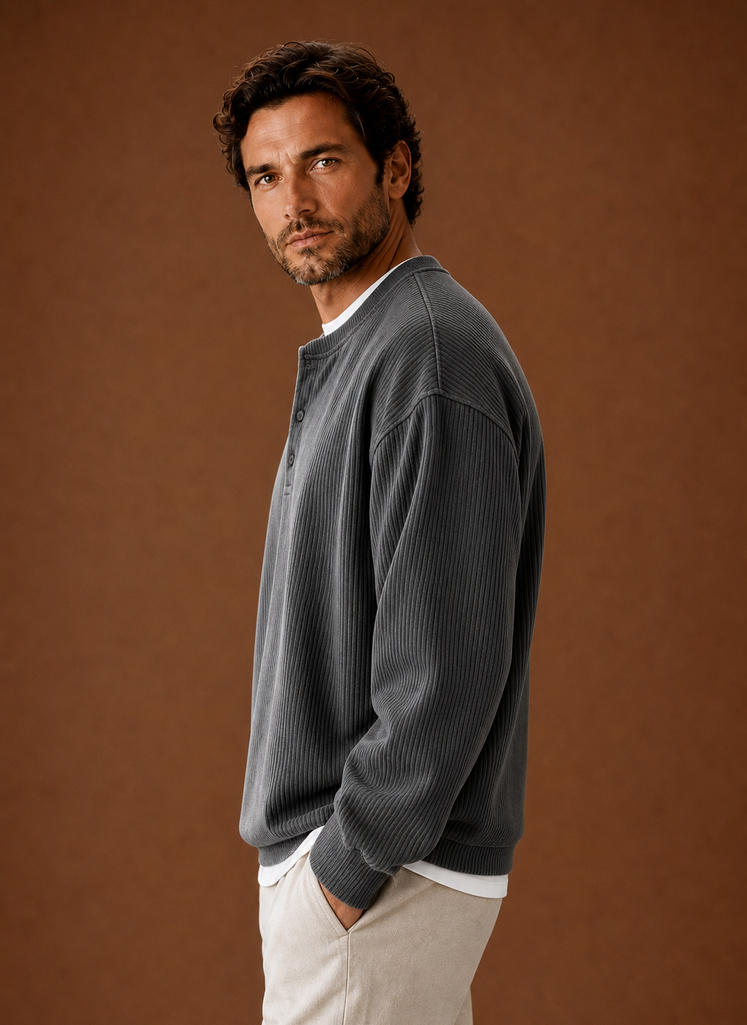 Side view of men's black ribbed henley shirt showing sleeve and shoulder