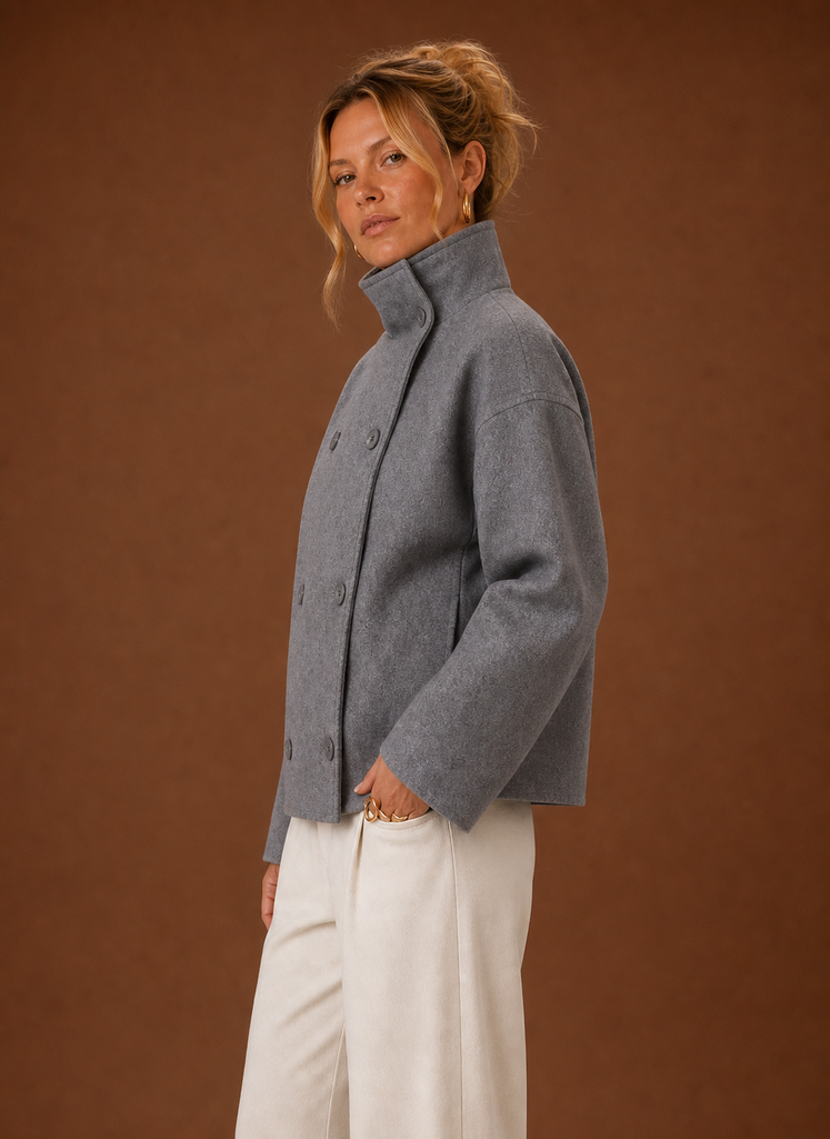 Side view of a women's funnel neck jacket in black