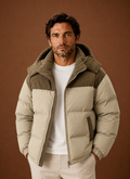 Front view of men's corduroy-trim quilted puffer jacket on a mannequin