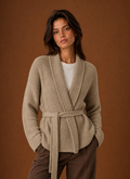 Front view of women's wrap sweater with chunky knit texture and self-tie belt