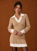 Front view of women's knit sweater dress on a mannequin showing midi length and crew neckline