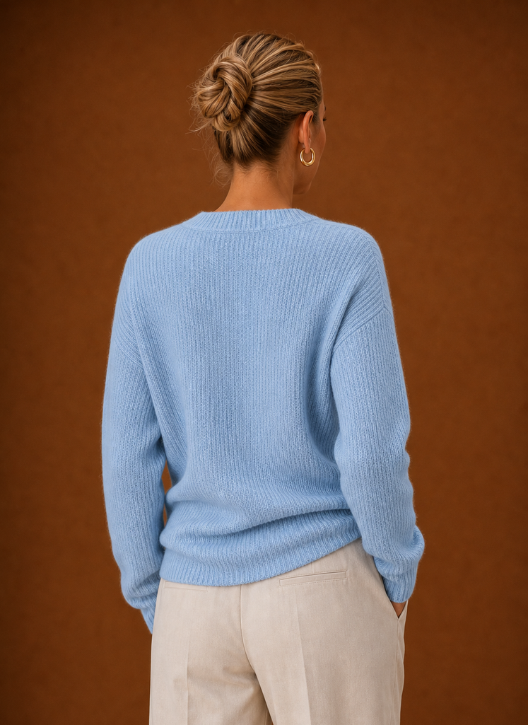 Back view showing ribbed knit back and clean hem of the wrap sweater