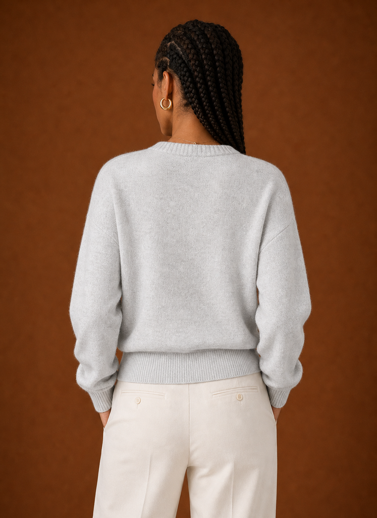Back view of the sweater showing smooth knit finish and cropped hem