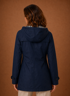 Back view of women's hooded trench coat showing hood and clean back seam