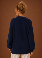 Back view of women's knit cardigan showing clean hemline and fitted shoulders