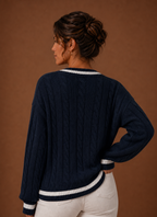 Back view of sweater showing cable knit pattern and hemline