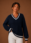 Front view of women's cable knit V-neck sweater on mannequin showing V-neck and textured knit