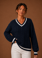 Front view of women's cable knit V-neck sweater on mannequin showing V-neck and textured knit