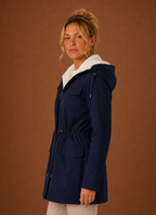 Side profile of the women's long hooded parka showing silhouette and hood