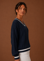 Side view of sweater showing long sleeve silhouette and knit drape