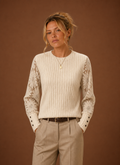 Front view of women's ribbed knit pullover sweater with lace sleeves