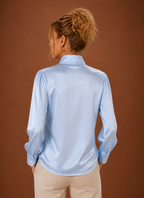 Back view of women's V-neck sweater showing clean finished hem and straight back silhouette
