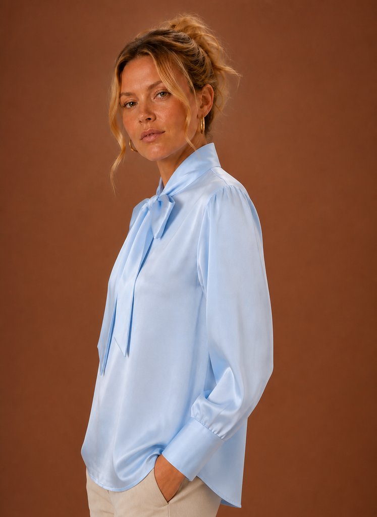 Side view of women's V-neck sweater displaying long sleeve and drape