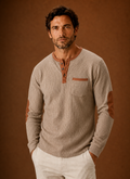 Front view of men's waffle-knit Henley long-sleeve shirt on a plain background
