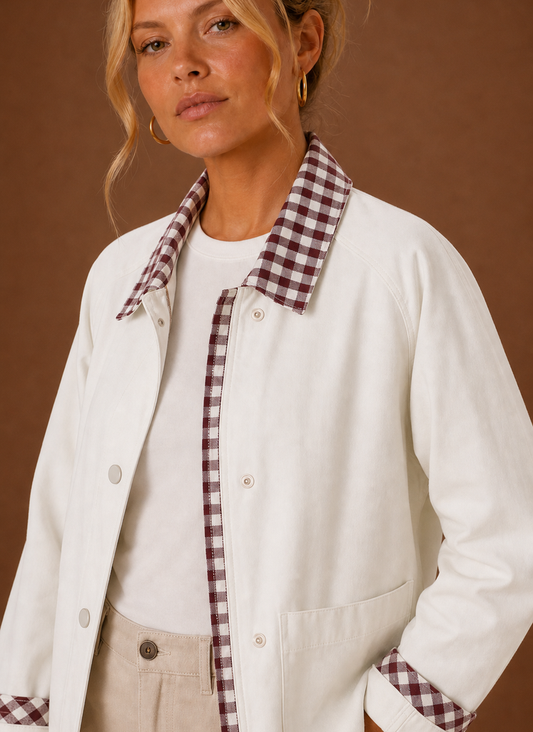Close-up of the contrast check collar, cuff detailing, and stitching