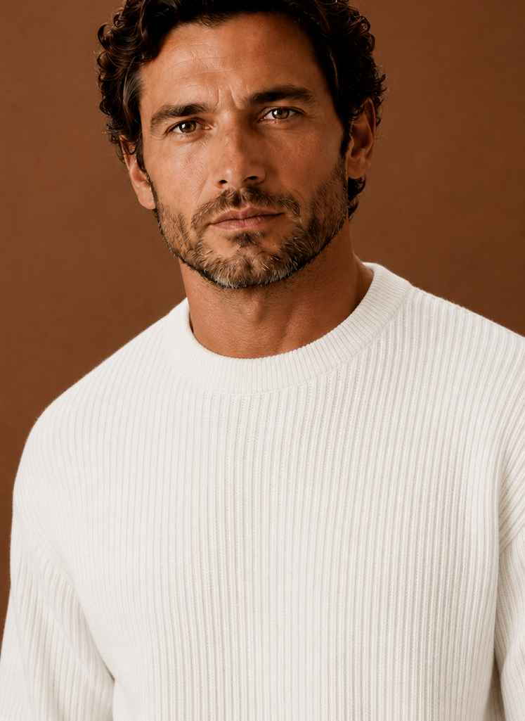 Close-up of ribbed neckline and cuff details on a men's white crewneck pullover