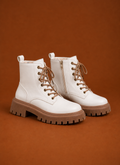 Front view of a women's lace-up ankle boot with chunky lug sole