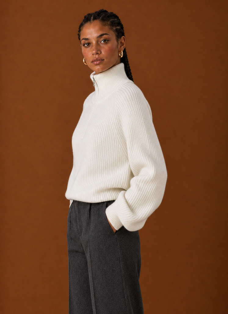 Side profile of the quarter-zip knit sweater showing the zip neckline and sleeve shape
