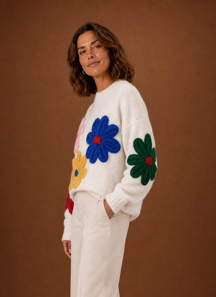 Side view of white oversized floral knit sweater highlighting relaxed fit and sleeve length