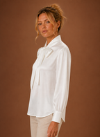 Side view of women's V-neck sweater displaying long sleeve and drape
