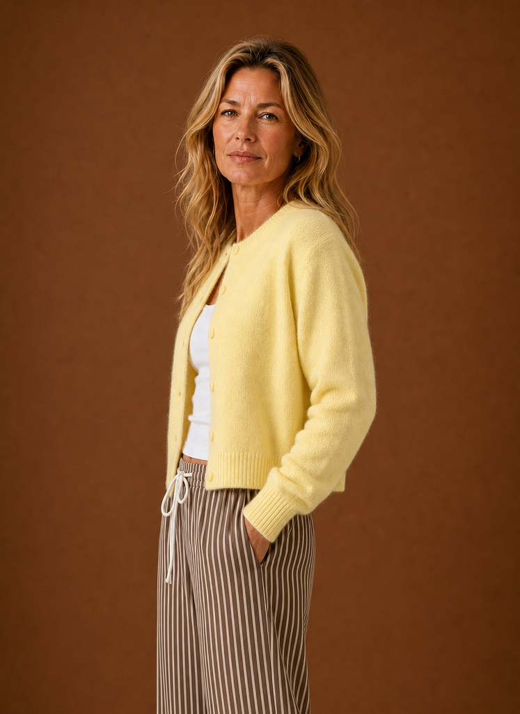 Side view of the women's crew neck cardigan showing the sleeve and button closure